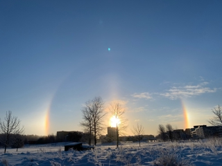 Sun halo with bi-suns over a winter landscape